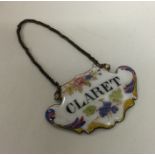 An Antique enamelled wine label for 'Claret' on su