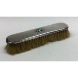 LIBERTY & CO: A silver mounted hairbrush inset wit