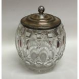 A silver and cut glass biscuit barrel with lift-of