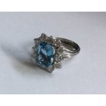 A large aquamarine and diamond cluster ring in ree