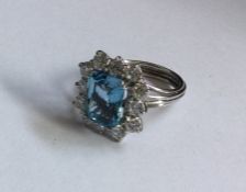 A large aquamarine and diamond cluster ring in ree