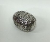 An 18th Century chased silver nutmeg grater of goo