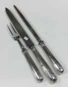 A Georgian silver three piece crested carving set.