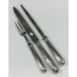 A Georgian silver three piece crested carving set.