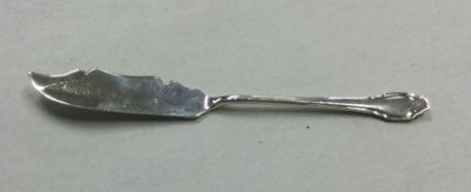 A small silver butter knife of shaped form. Sheffi