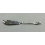 A small silver butter knife of shaped form. Sheffi