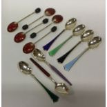 A collection of silver and enamelled spoons of var