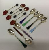 A collection of silver and enamelled spoons of var