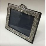 A rectangular chased silver picture frame. London.
