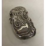 A heavy silver vesta case decorated with scrolls a