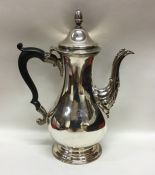 A heavy baluster shaped Georgian silver coffee pot