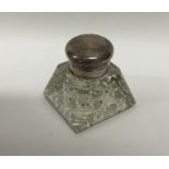 A small square capstan shaped silver inkwell with