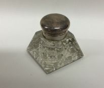 A small square capstan shaped silver inkwell with