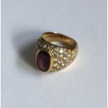 A ruby and diamond ring in 18 carat gold rubover m