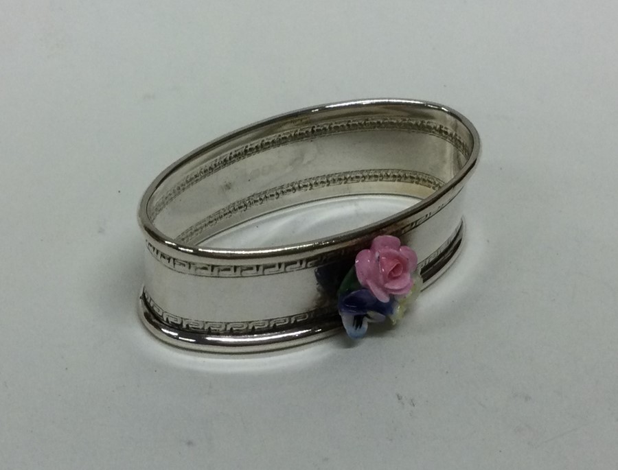 A silver and porcelain mounted napkin ring decorat