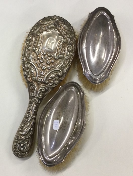 A group of three silver mounted hairbrushes. Est.