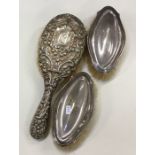 A group of three silver mounted hairbrushes. Est.