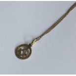 A 9 carat Masonic pendant on fine link chain. Appr
