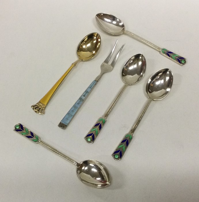A mixed selection of silver and enamelled spoons.