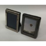 A pair of modern silver miniature picture frames.