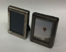 A pair of modern silver miniature picture frames.