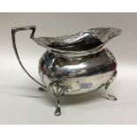 A heavy Edwardian silver cream jug with card cut r