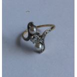 A stylish Art Nouveau pearl and diamond ring in go