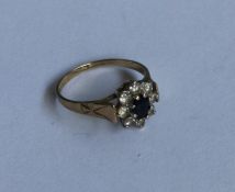 A sapphire and diamond daisy head cluster ring in