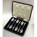 A cased set of six silver coffee spoons with reede