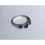 A 9 carat amethyst and diamond twist ring in claw