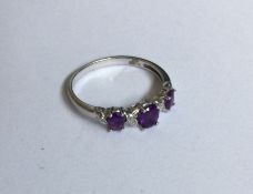 A 9 carat amethyst and diamond twist ring in claw