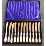 A cased set of twelve silver mounted knives of flu