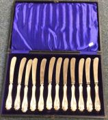 A cased set of twelve silver mounted knives of flu
