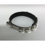 A rare silver and leather dog collar with ball mou