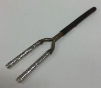 A pair of silver mounted curling tongs decorated w