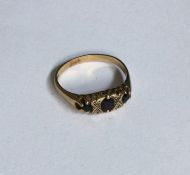 A sapphire and diamond mounted seven stone ring. A