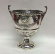 An unusual urn shaped silver vase decorated with s