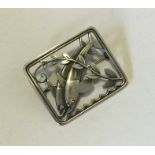 GEORG JENSEN. A rectangular silver brooch mounted