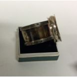 A heavy silver napkin ring together with one other