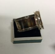 A heavy silver napkin ring together with one other