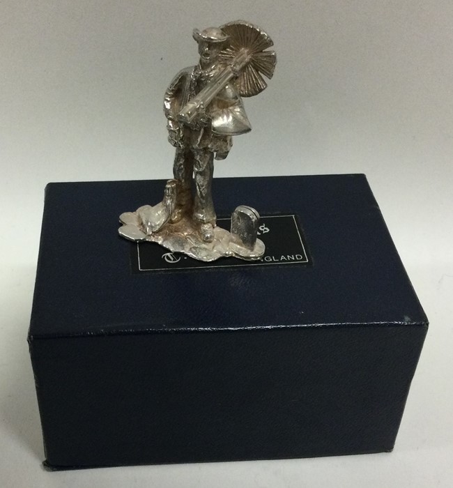 A cast silver figure of a chimney sweep in present