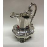 A good Victorian panelled silver cream jug on scro