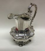 A good Victorian panelled silver cream jug on scro