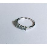 An aquamarine and diamond five stone ring in claw