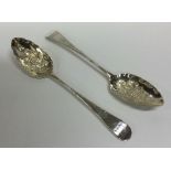 A pair of large crested silver berry spoons with g