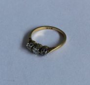 A good diamond three stone ring in two colour gold