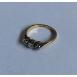 A good diamond three stone ring in two colour gold