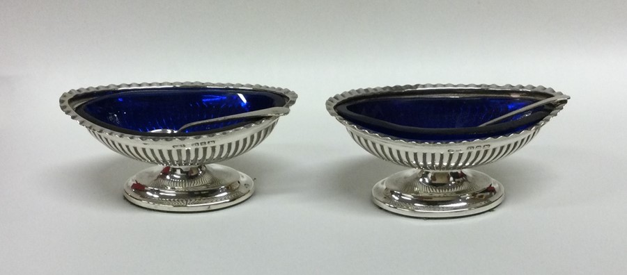 A pair of Edwardian silver salts together with spo