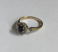 A small sapphire and diamond circular cluster ring