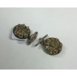 A pair of silver filigree cufflinks of circular fo